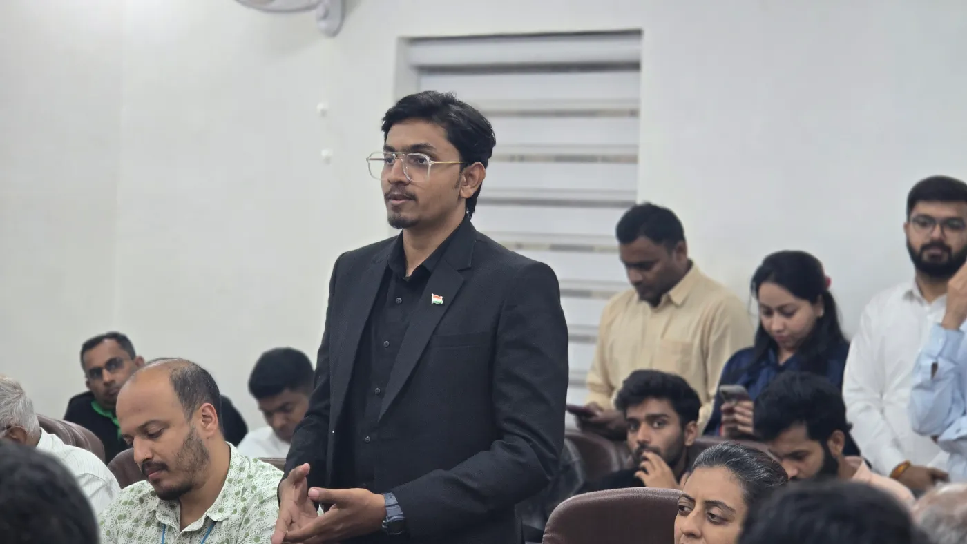 Mohammed Kabeer speaking to a seated audience at an outreach session