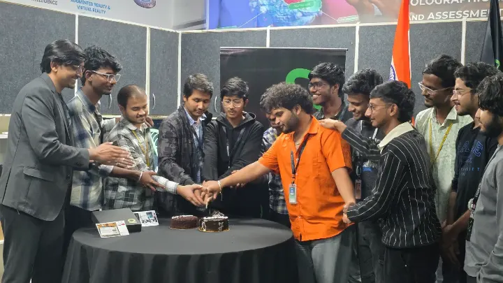 Team members cutting a cake together