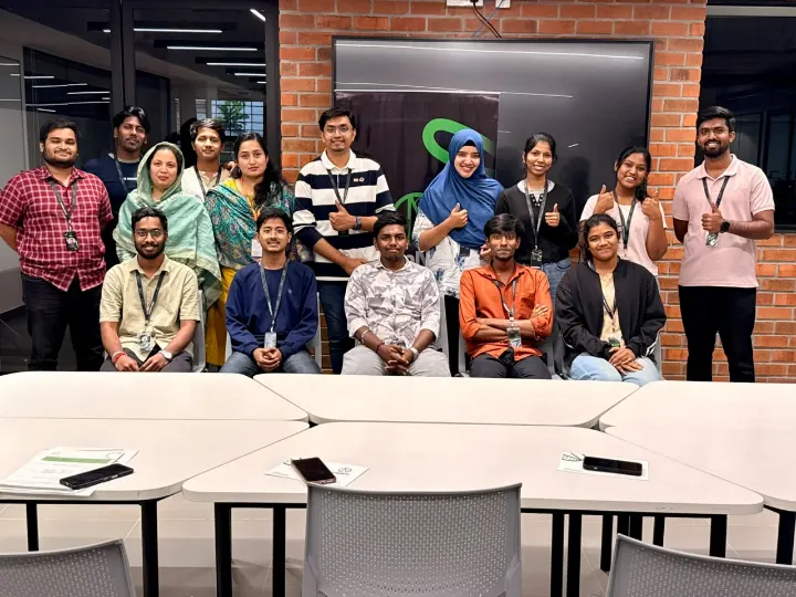 A large group posing together in a meeting room