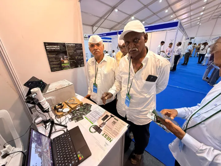 Farmers looking at NEST at an exhibition stall