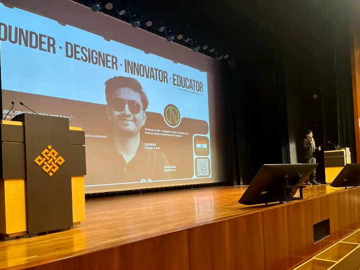 Mohammed Kabeer introduced on a large screen above a stage