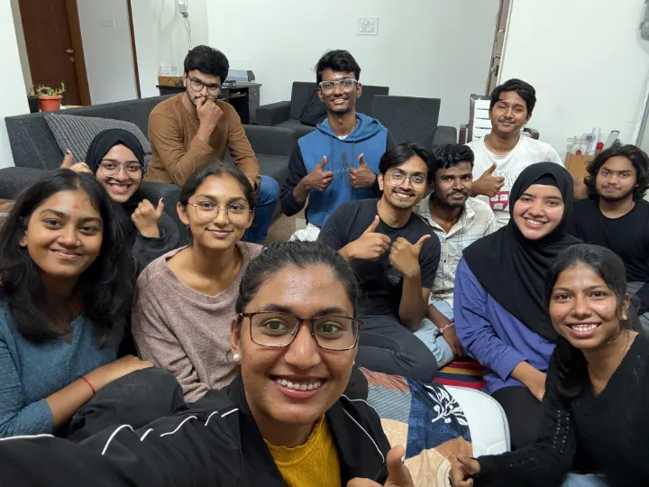 A group selfie of team members sitting close together