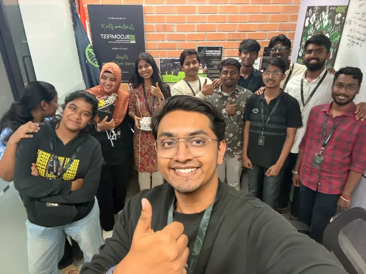 A group selfie with a smiling team member in front
