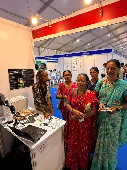 Women farmers standing at the CropNow stall